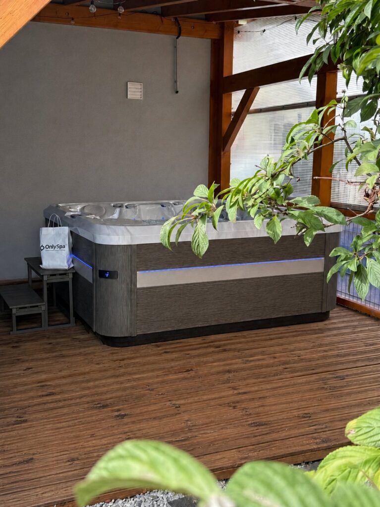 Spa dans un espace abrité avec terrasse en bois — réalisation Onlyspa